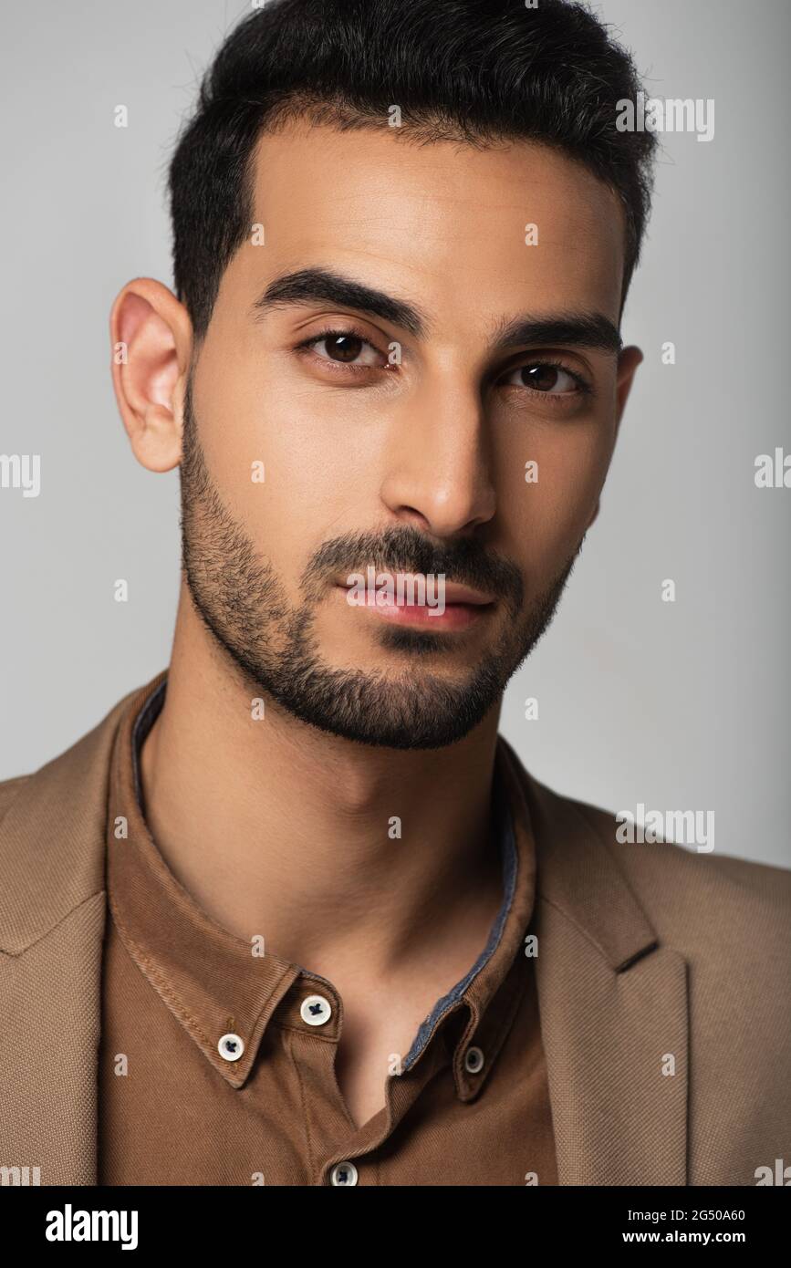 Good looking arabian man in formal wear isolated on grey Stock Photo - Alamy