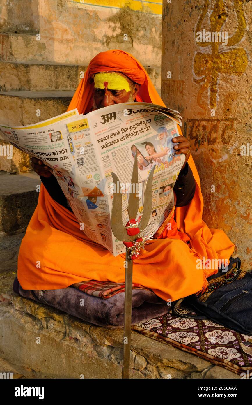 VARANASI, INDIA: Indian man reading news in morning newspaper on the varanasi ghat of historical city on February 3, 2021. Stock Photo