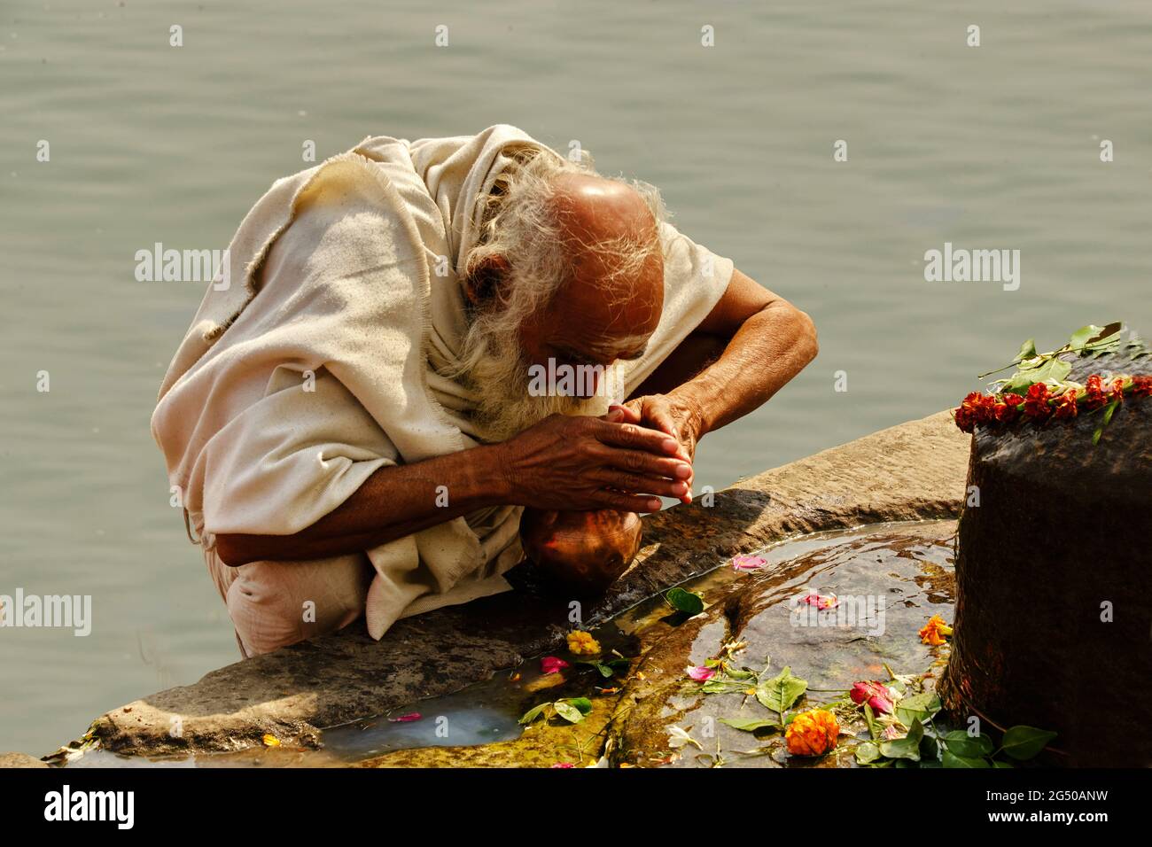 Varanasi, India - February 03, 2021, Old Man praying to Lord Shiva front of Ganga river. Stock Photo