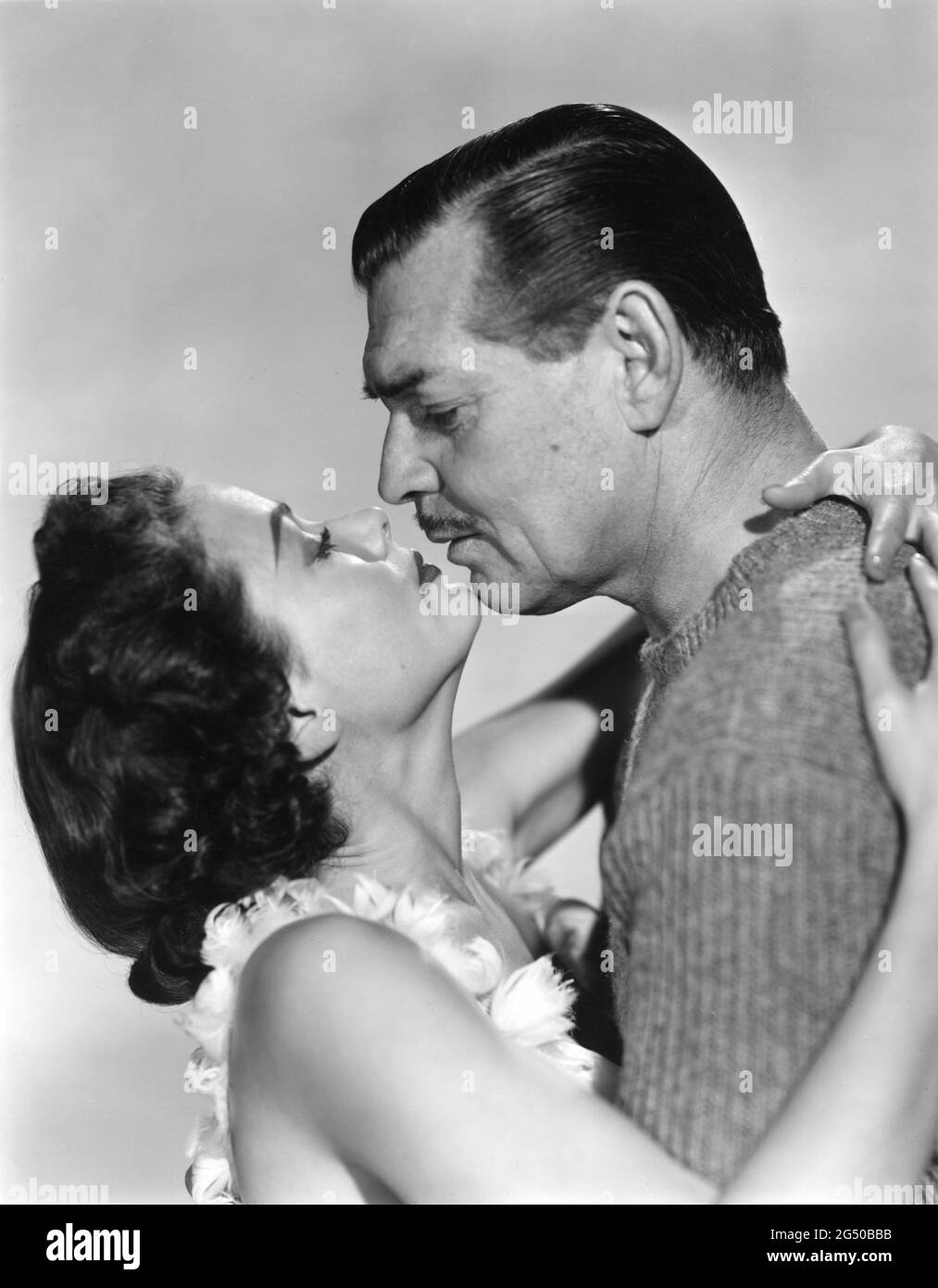 GENE TIERNEY and CLARK GABLE Unretouched Publicity Portrait in NEVER LET ME GO 1953 director DELMER DAVES from novel Come The Dawn by Paul Winterton producer Clarence Brown Metro Goldwyn Mayer Stock Photo