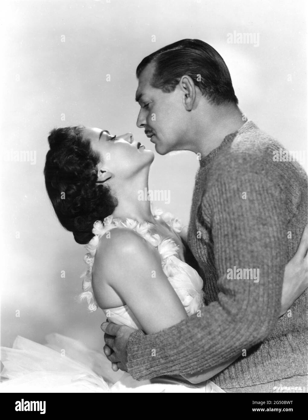 GENE TIERNEY and CLARK GABLE Publicity Portrait in NEVER LET ME GO 1953 director DELMER DAVES from novel Come The Dawn by Paul Winterton producer Clarence Brown Metro Goldwyn Mayer Stock Photo