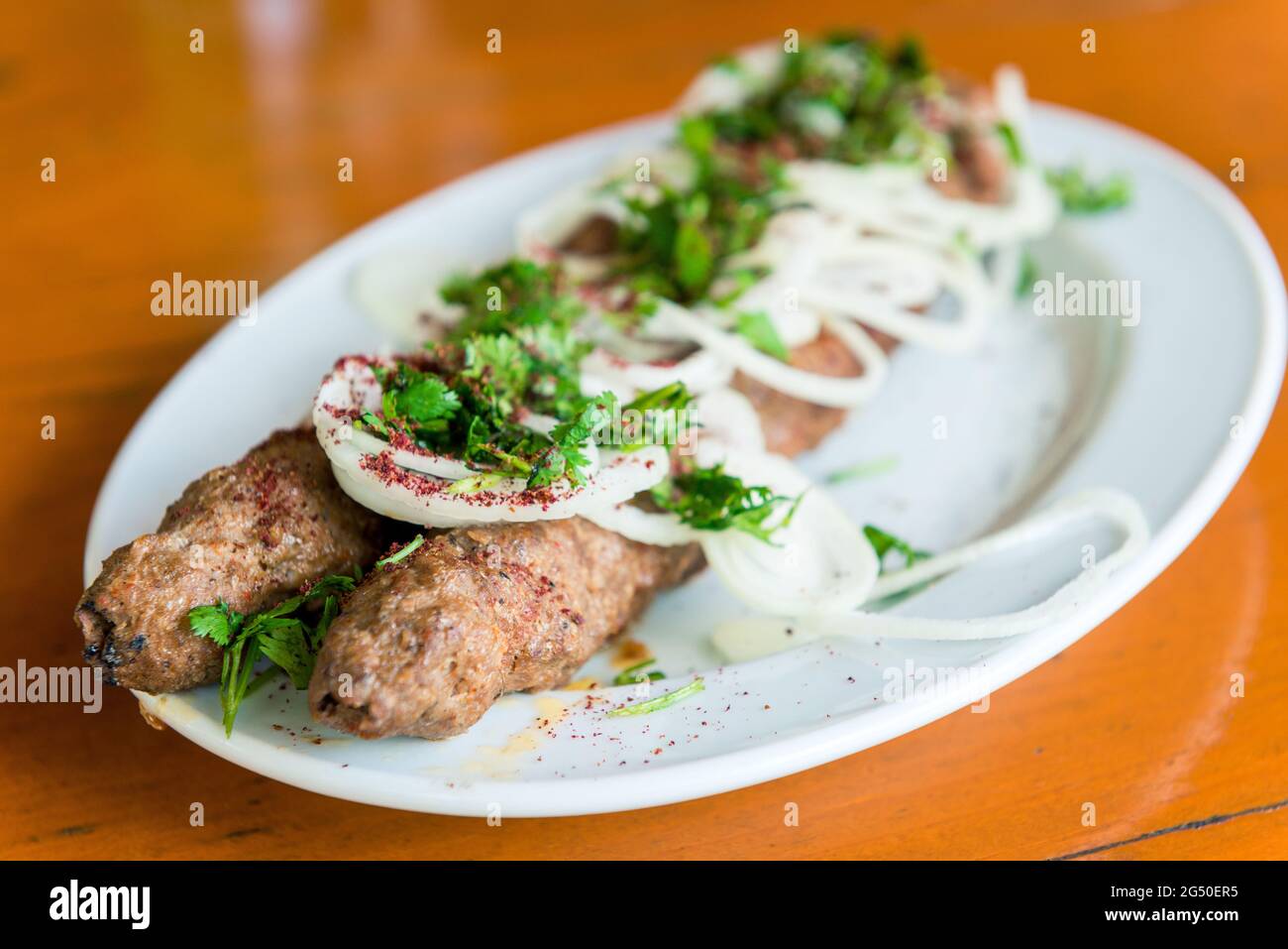 Grilled kebabs on the plate and fresh vegetables Stock Photo