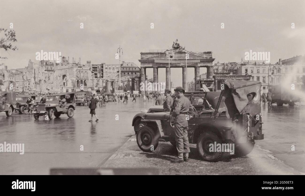 Vintage photo of occupied Berlin in 1945. Photograph shows servicemen near the Brandenburg Gate in occupied Berlin after World War II ended in Europe. Stock Photo
