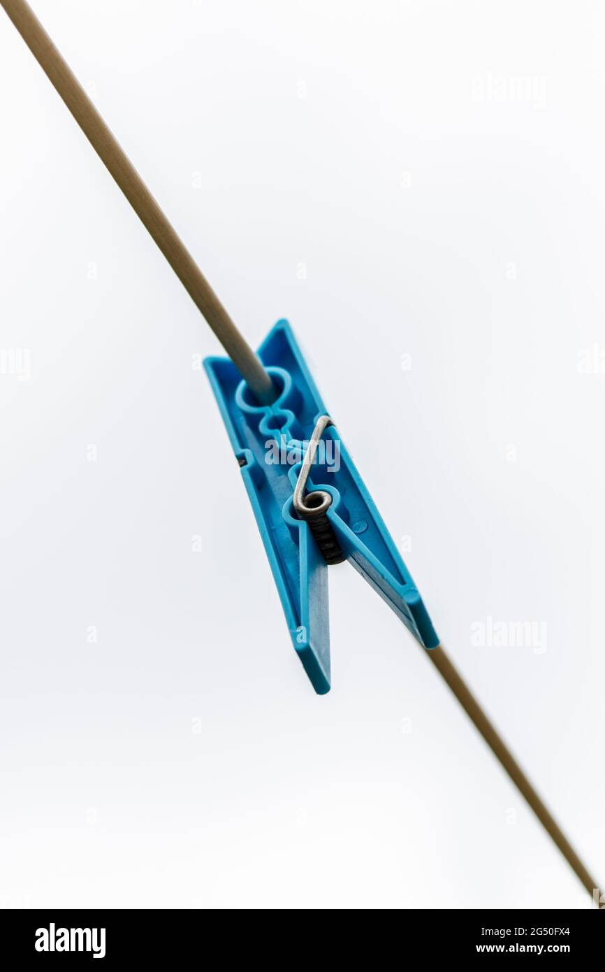 Colored clothes peg hanging by a thread Stock Photo Alamy