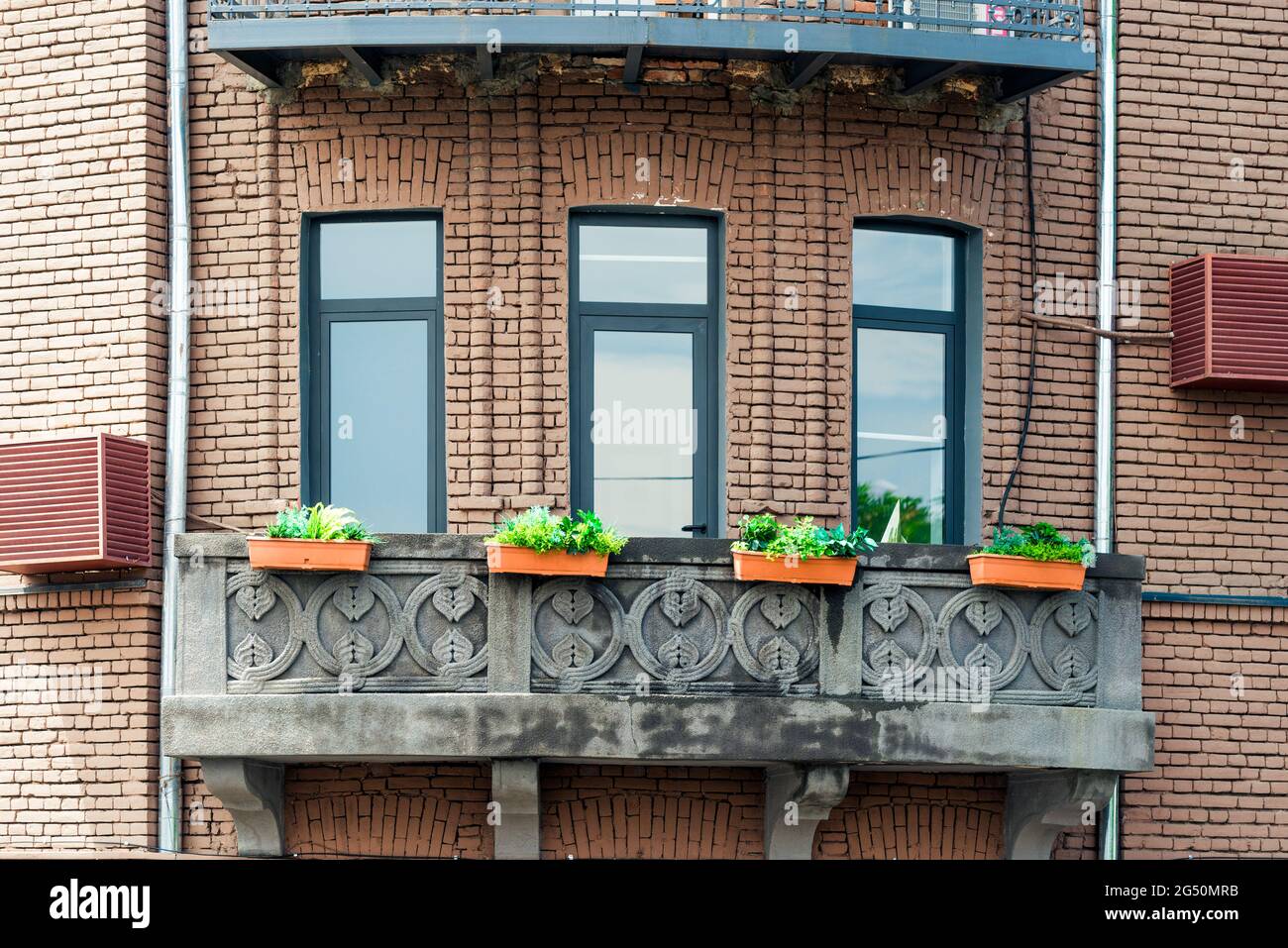 Facade of  brick house with balcony Stock Photo
