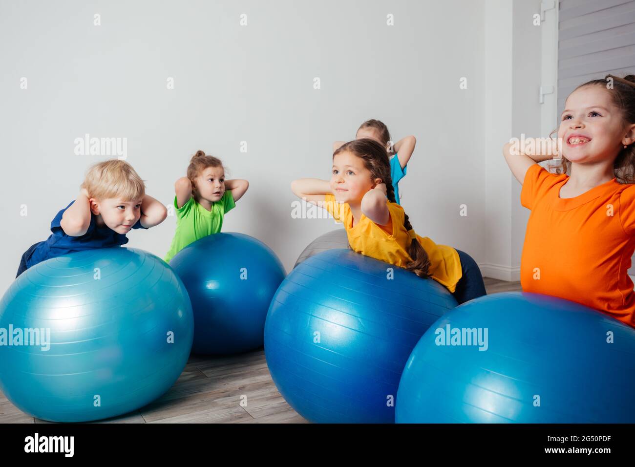 Kids doing physical exercises on large fitballs Stock Photo - Alamy