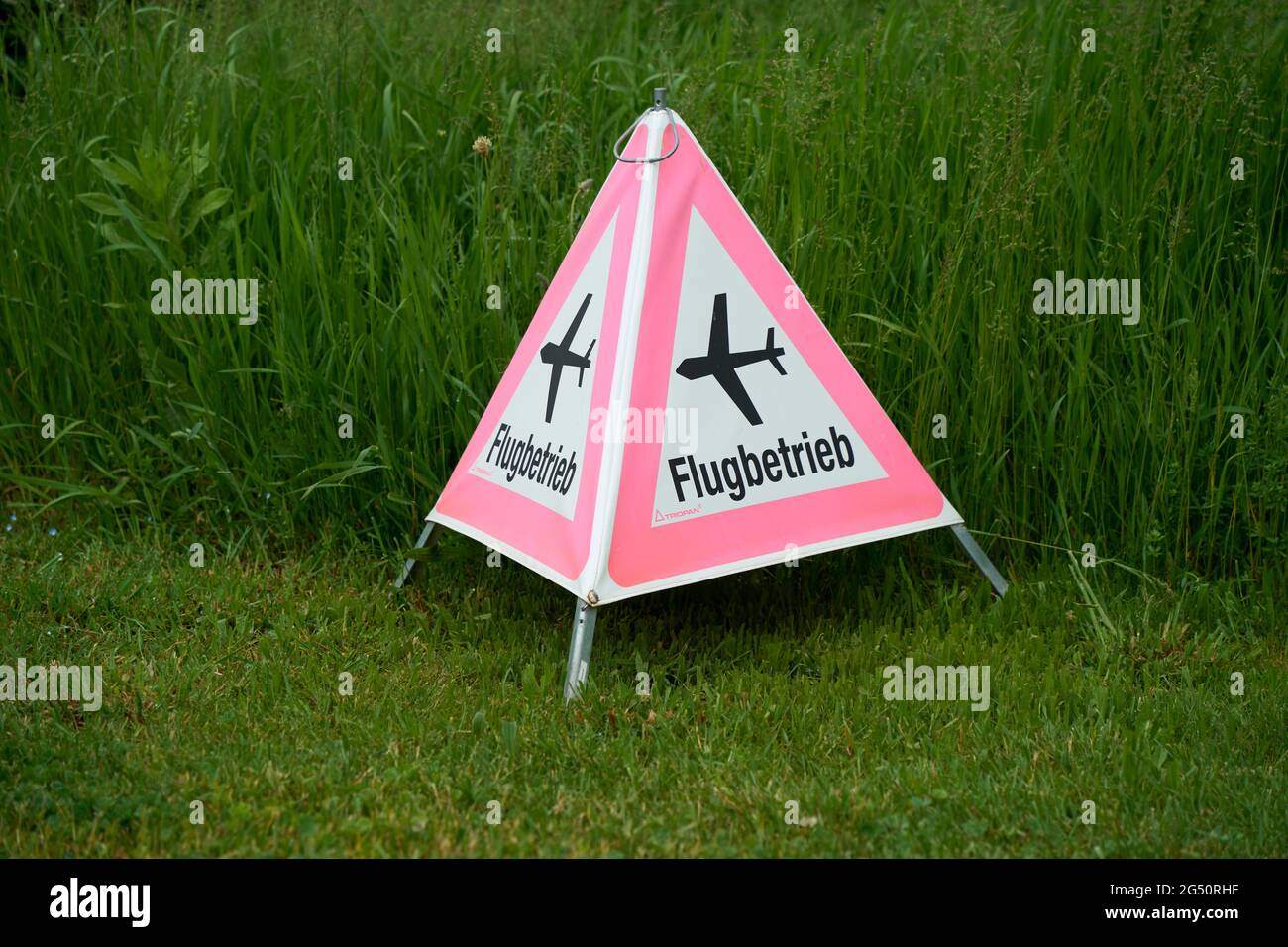 Folding Signal Warning Of Flight Operations On A Green Meadow, Fehraltorf, Switzerland Stock Photo
