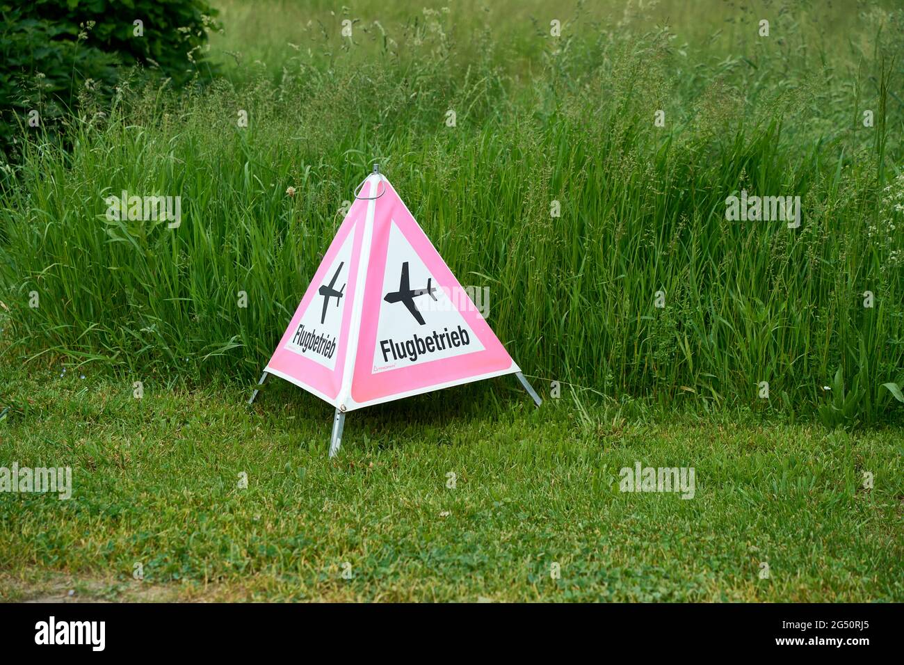 Folding Signal Warning Of Flight Operations On A Green Meadow, Fehraltorf, Switzerland Stock Photo