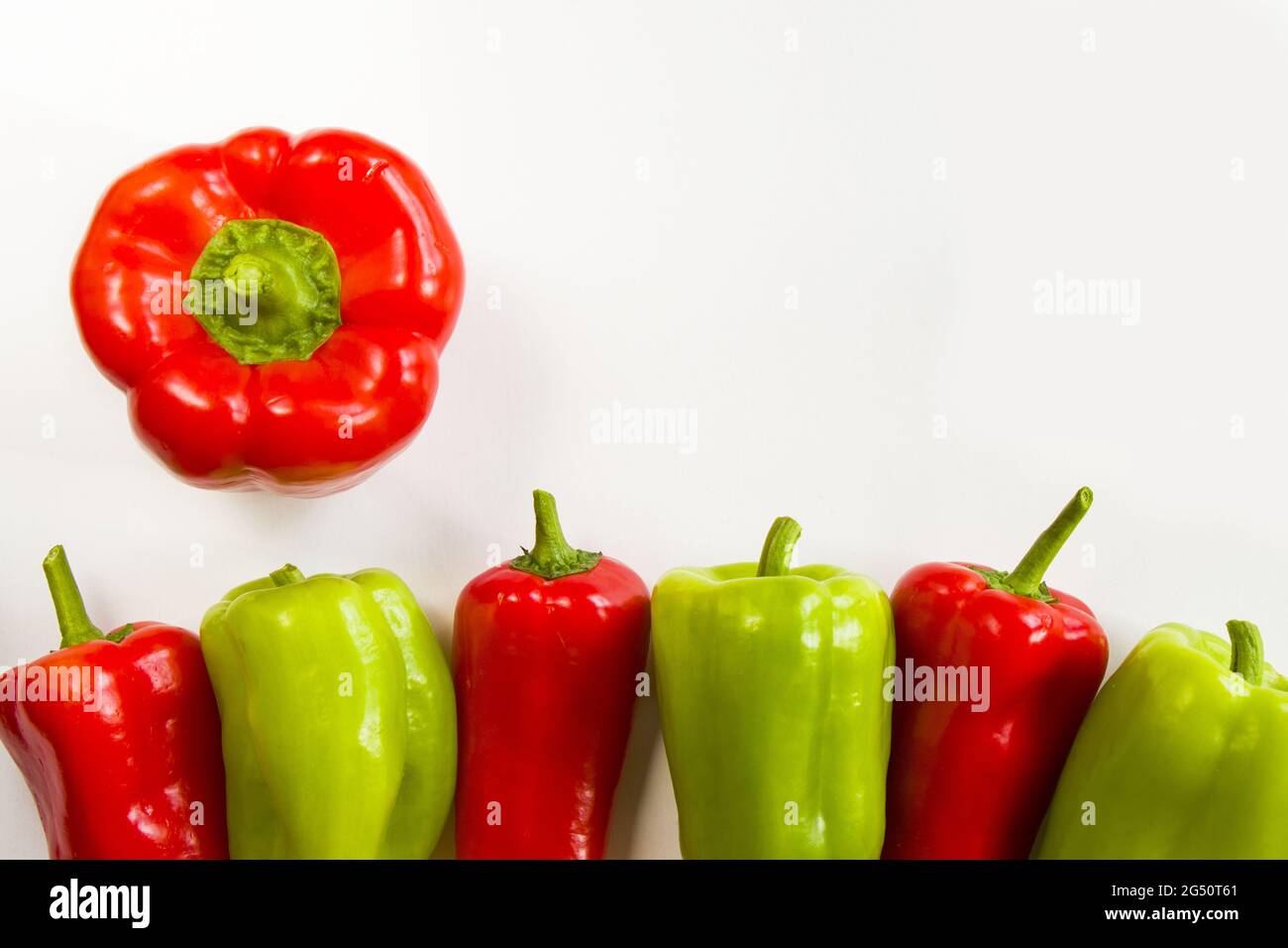 Top view of ripe red and green bell peppers isolated on white ...