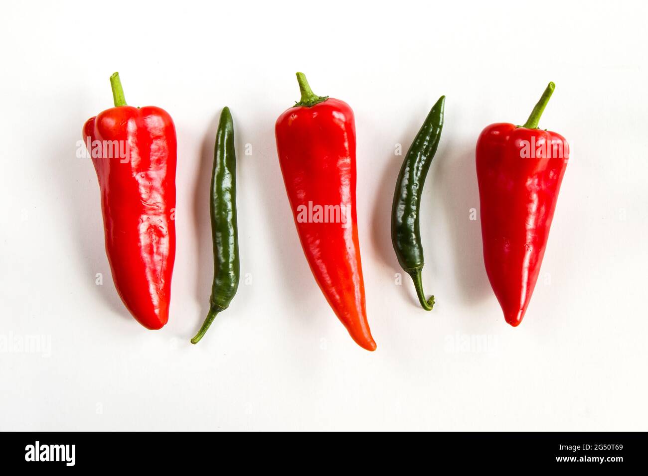 Top view of ripe red bell peppers and green chili peppers isolated on ...