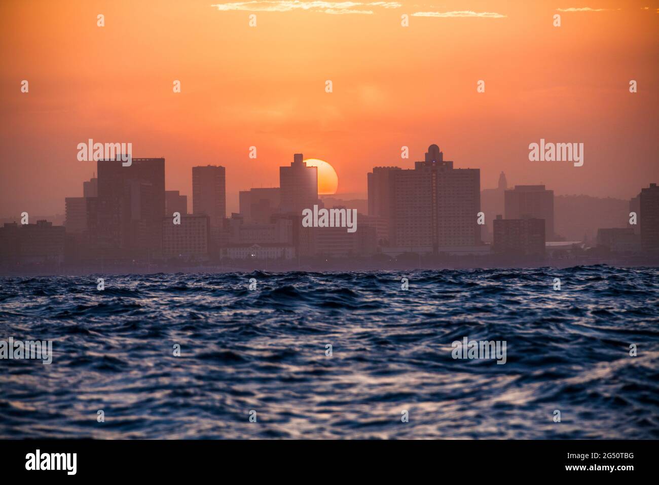 Approaching Durban from sea at sunset with big waves on the Indian