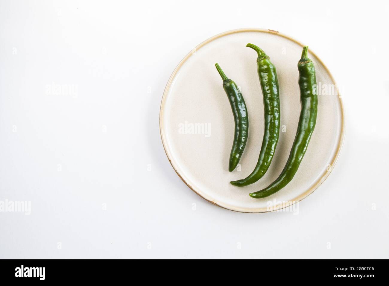 Top view of green chili peppers on th isolated on white background for ...