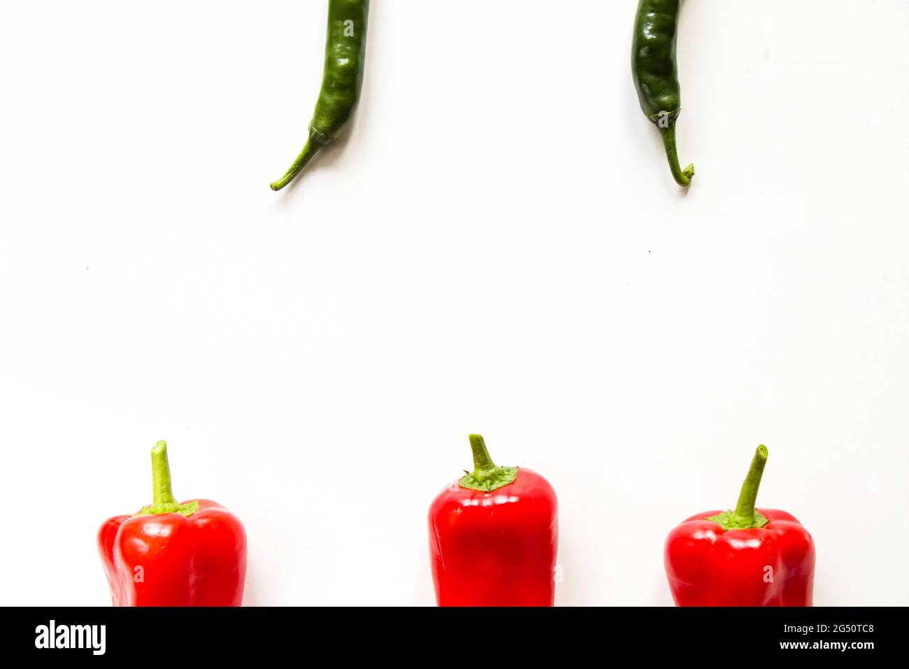 Top view of ripe red bell peppers and green chili peppers isolated on ...