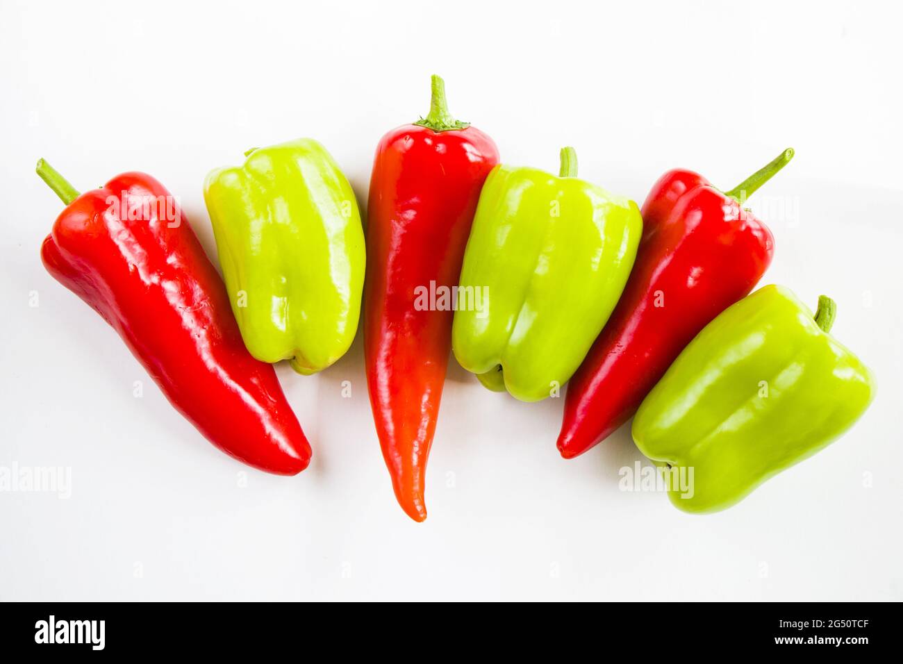 Top view of ripe red and green bell peppers isolated on white ...