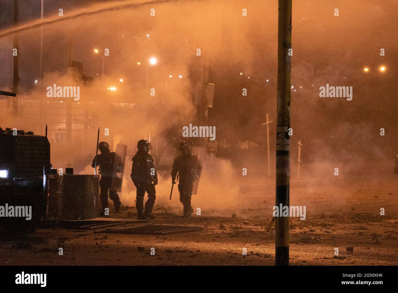 Bogota, Colombia. 23rd June, 2021. Colombian riot police officers (ESMAD) use tear gas grenades and canisters to disperse demonstrators as demonstrations rise into clashes between demonstrators and Colombia's riot police (ESMAD) in northern Bogota, Colombia on june 22 after a demonstrator died in a police abuse of authority case during clashes with Colombia's riot police (ESMAD) on June 22, 2021. Credit: Long Visual Press/Alamy Live News Stock Photo