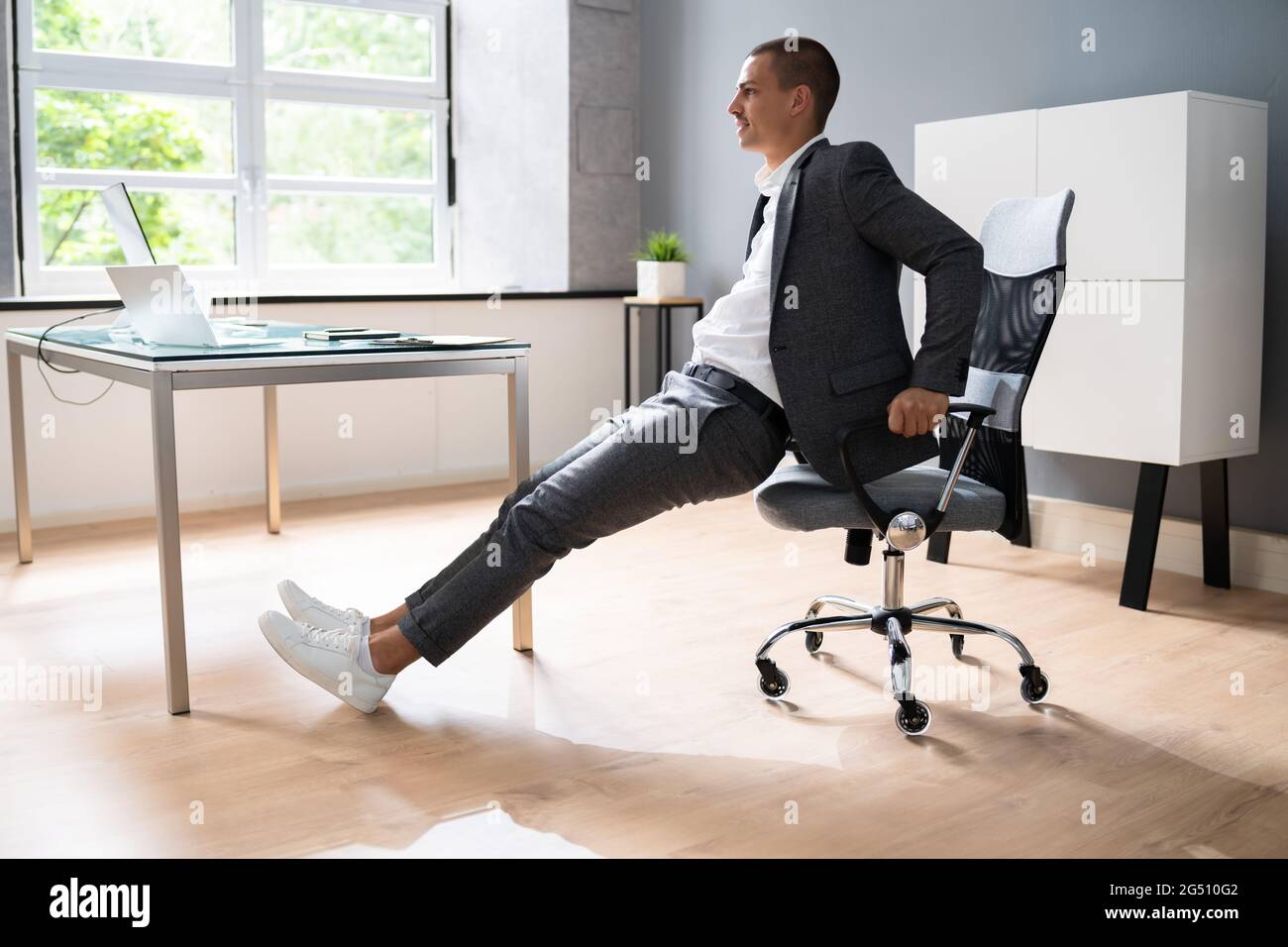 Chair Triceps Dip In Office. Workout Exercise At Desk Stock Photo - Alamy