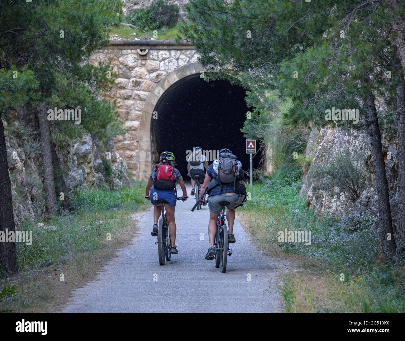 Cycling on the Val de Zafán greenway between Bot and Xerta villages (Tarragona, Catalonia, Spain) ESP: Ciclismo en la Vía Verde de la Val de Zafán Stock Photo