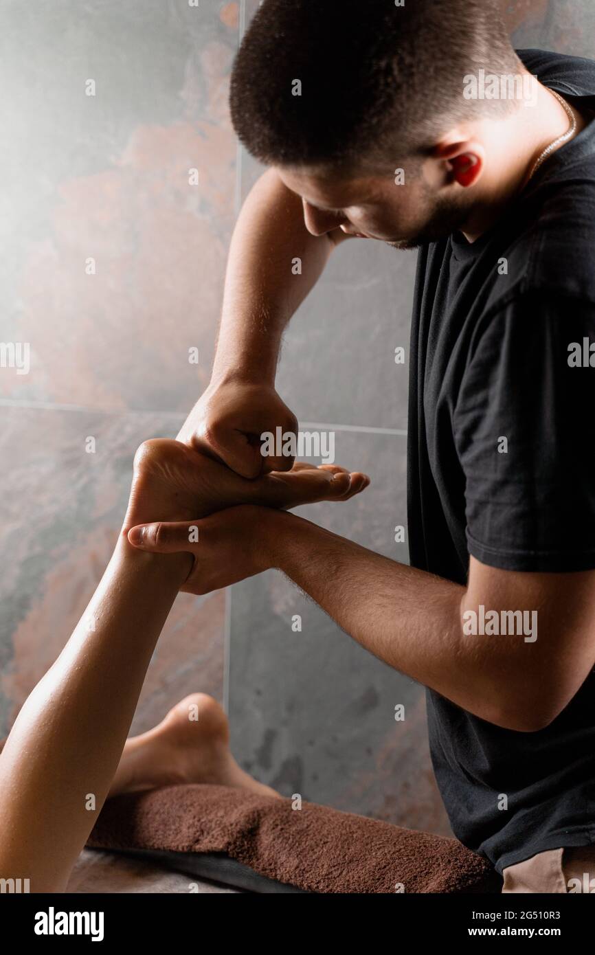 4 hands massage of legs and feet in spa. Professional masseur making