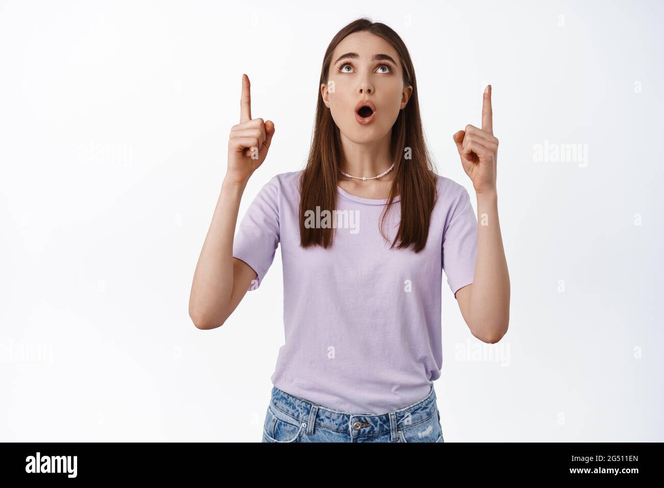 Image of amazed girl stared in awe at advertisement, pointing fingers