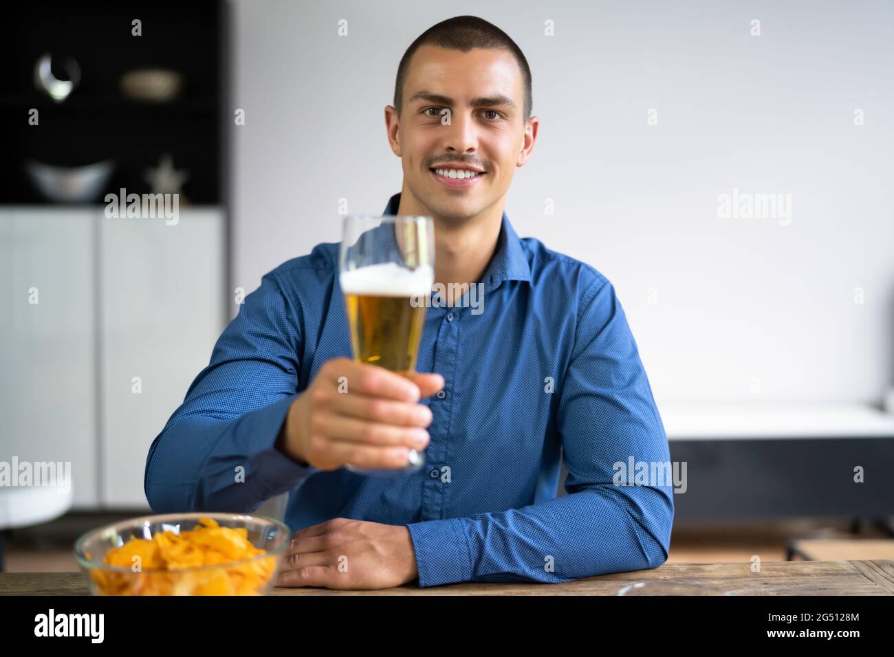 Man Beer Drinking Video Conference Chat In Room Stock Photo