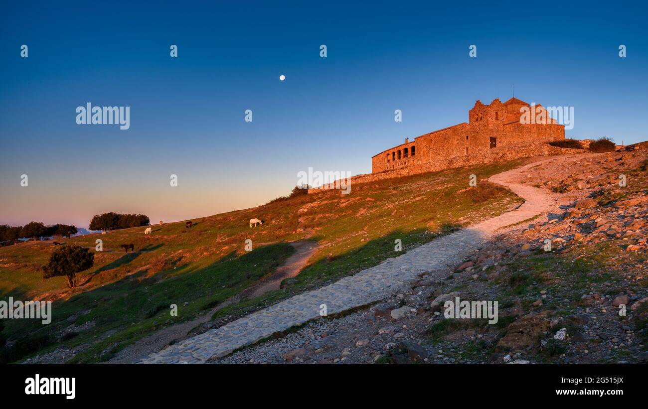 Sant Llorenç del Munt monastery at sunrise with the full moon (Vallès Occidental, Barcelona, Catalonia, Spain) Stock Photo