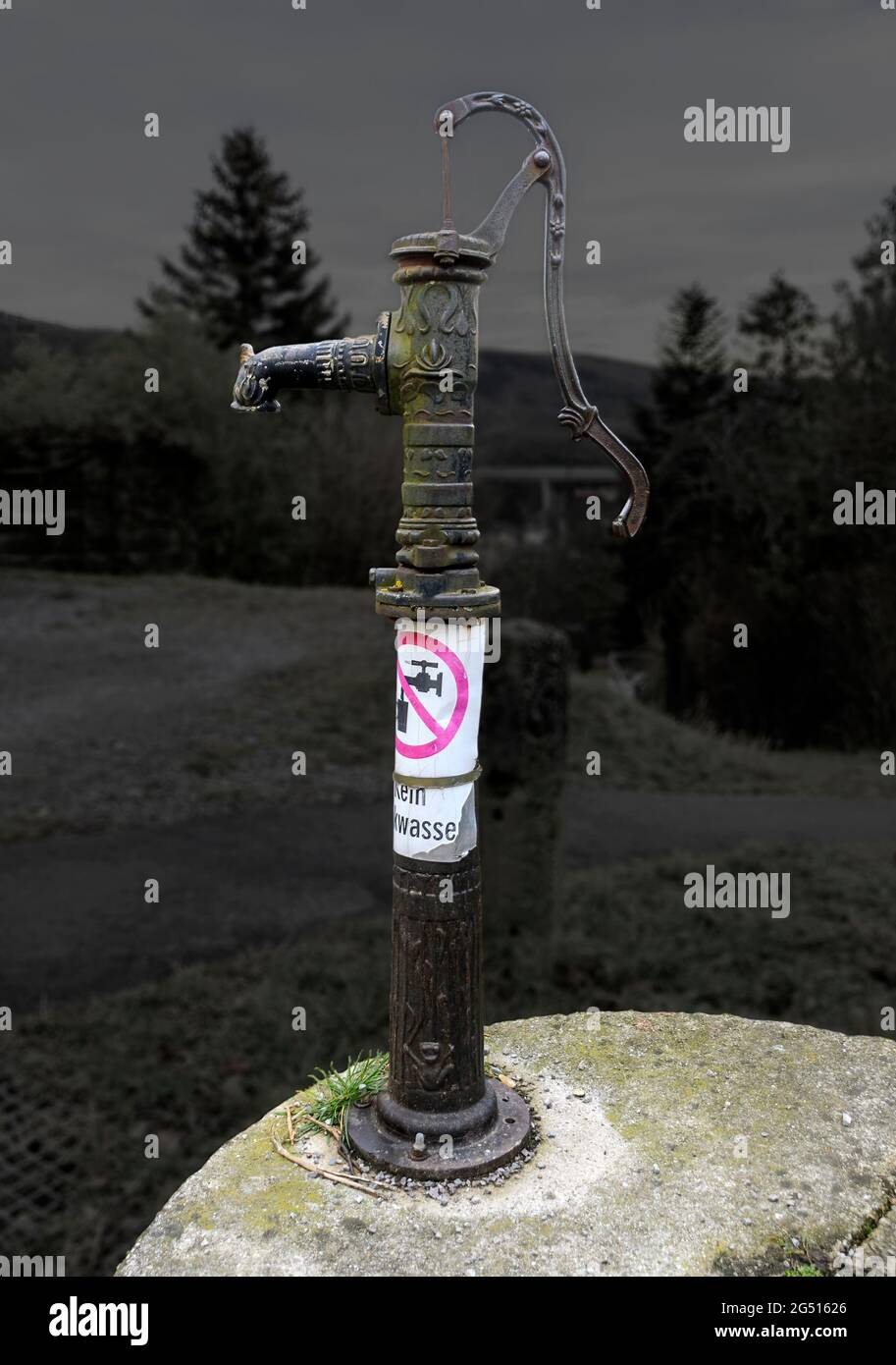 old iron suction hand pump with the poster 'No drinking water' Stock Photo