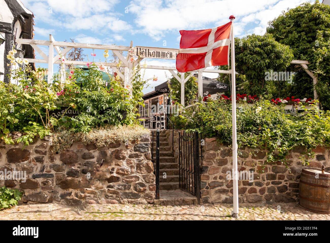 Ebeltoft, Denmark - 20 July 2020: Old restaurant, house with half-timbering, Dannebrog flag, Stock Photo