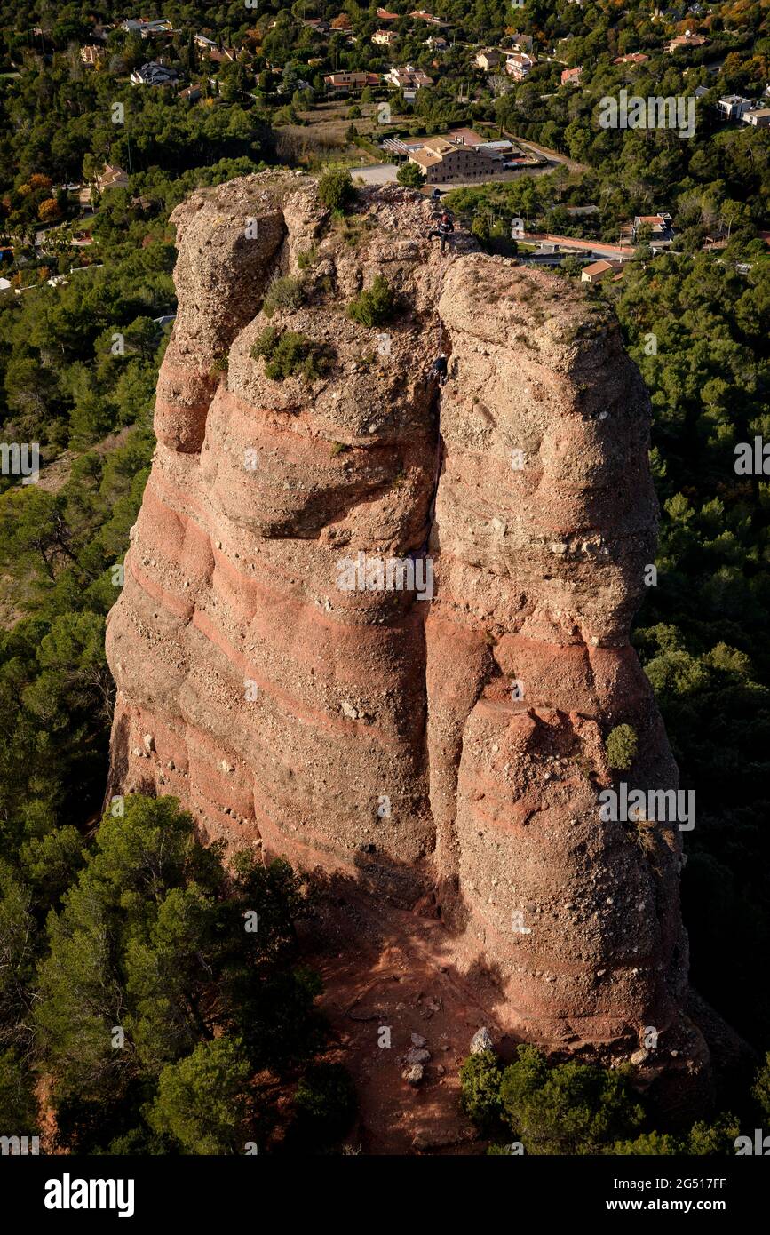 A climber descending the Cavall Bernat rock in Matadepera, in Sant Llorenç del Munt i l'Obac (Barcelona, Catalonia, Spain) Stock Photo