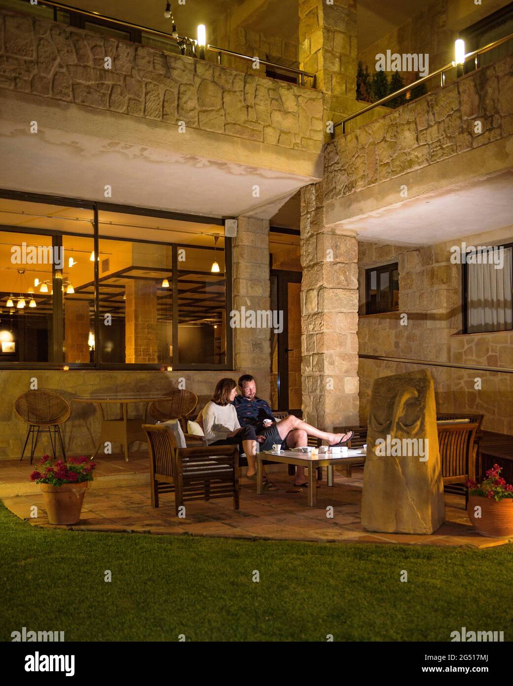 A couple enjoying the evening in the garden of Les Capçades Hotel in Horta de Sant Joan (Terra Alta, Tarragona, Catalonia, Spain) Stock Photo