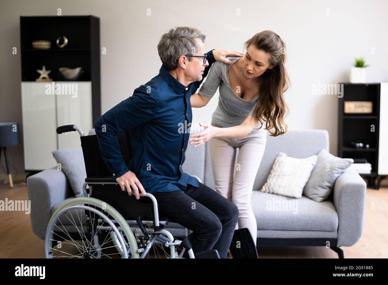 Nurse Giving Care To Older Patient In Wheelchair Stock Photo