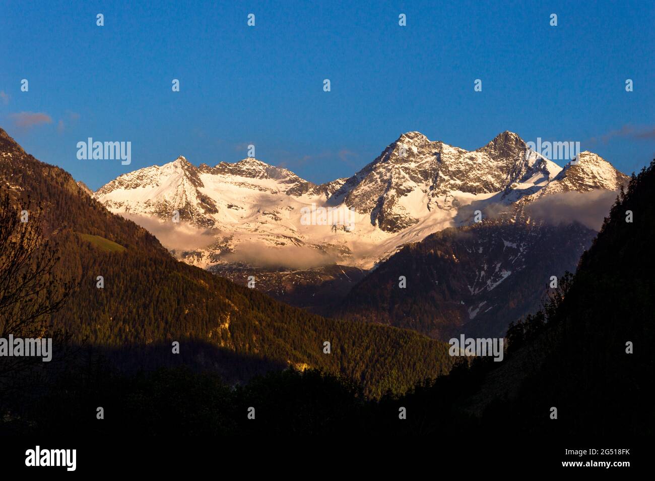 Sun rays on mountains peaks and valley at sun set time in Val D'Ayas in ...