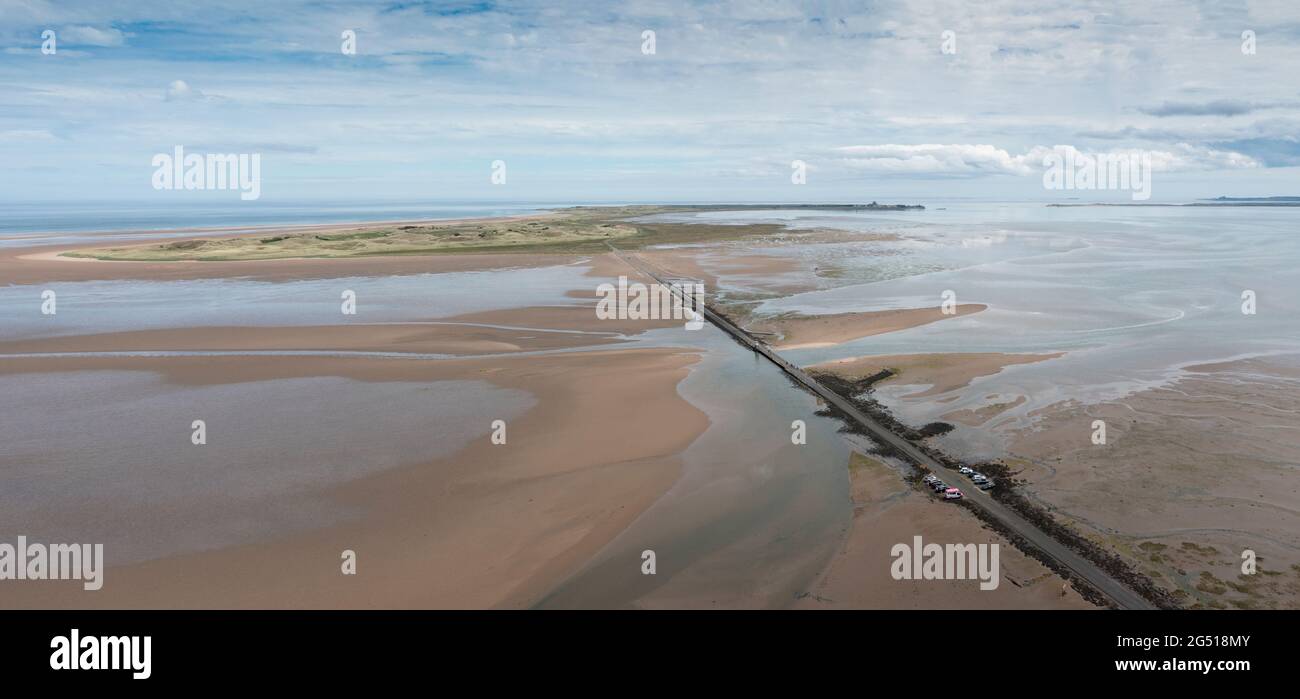 Aerial view of the Lindisfarne, (Holy Island) causeway that links it to the Northumberland mainland. The Causeway get covered by the sea at high tide Stock Photo