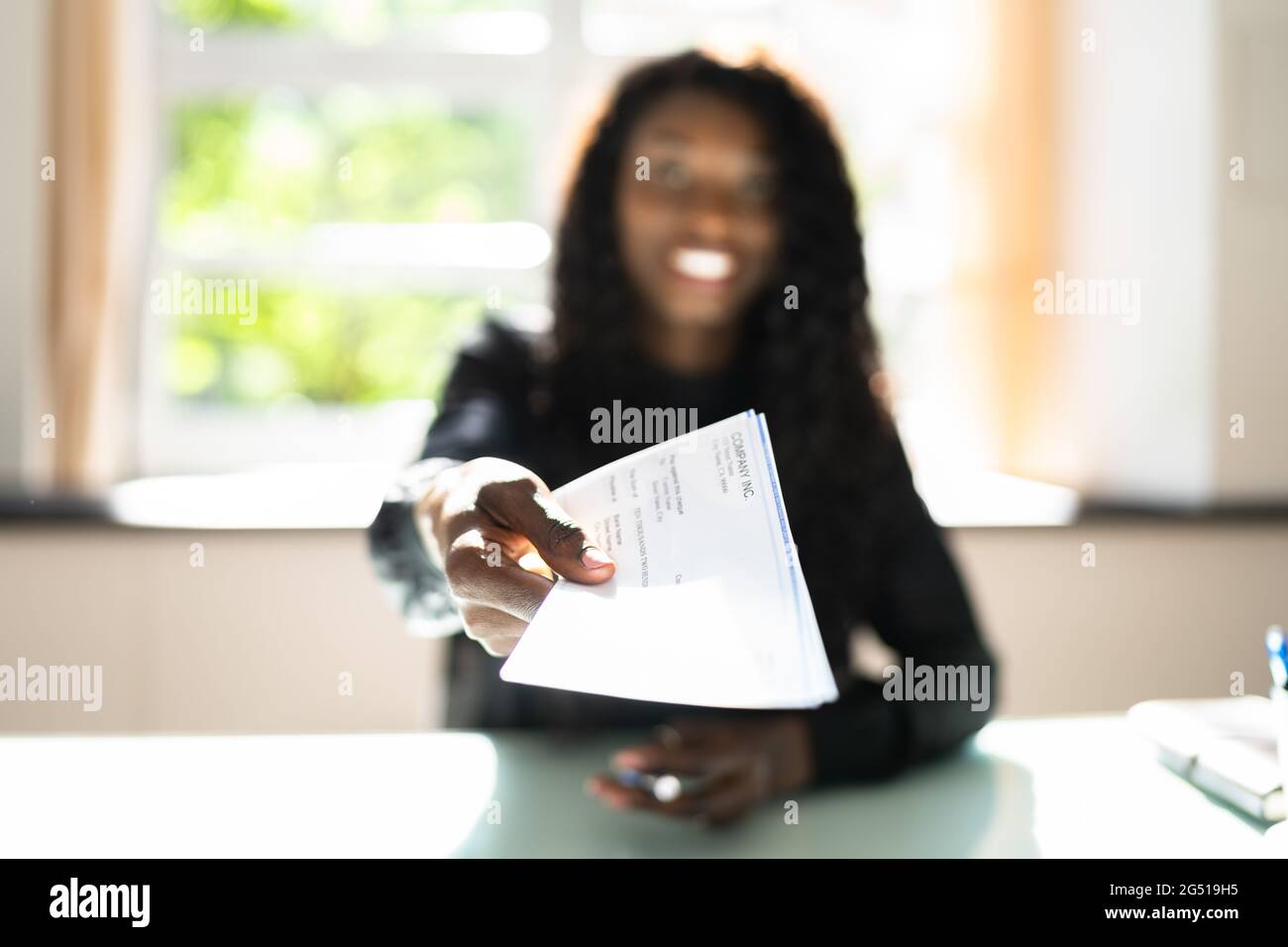 African Business Woman Giving Paycheck Or Payroll Cheque Stock Photo ...