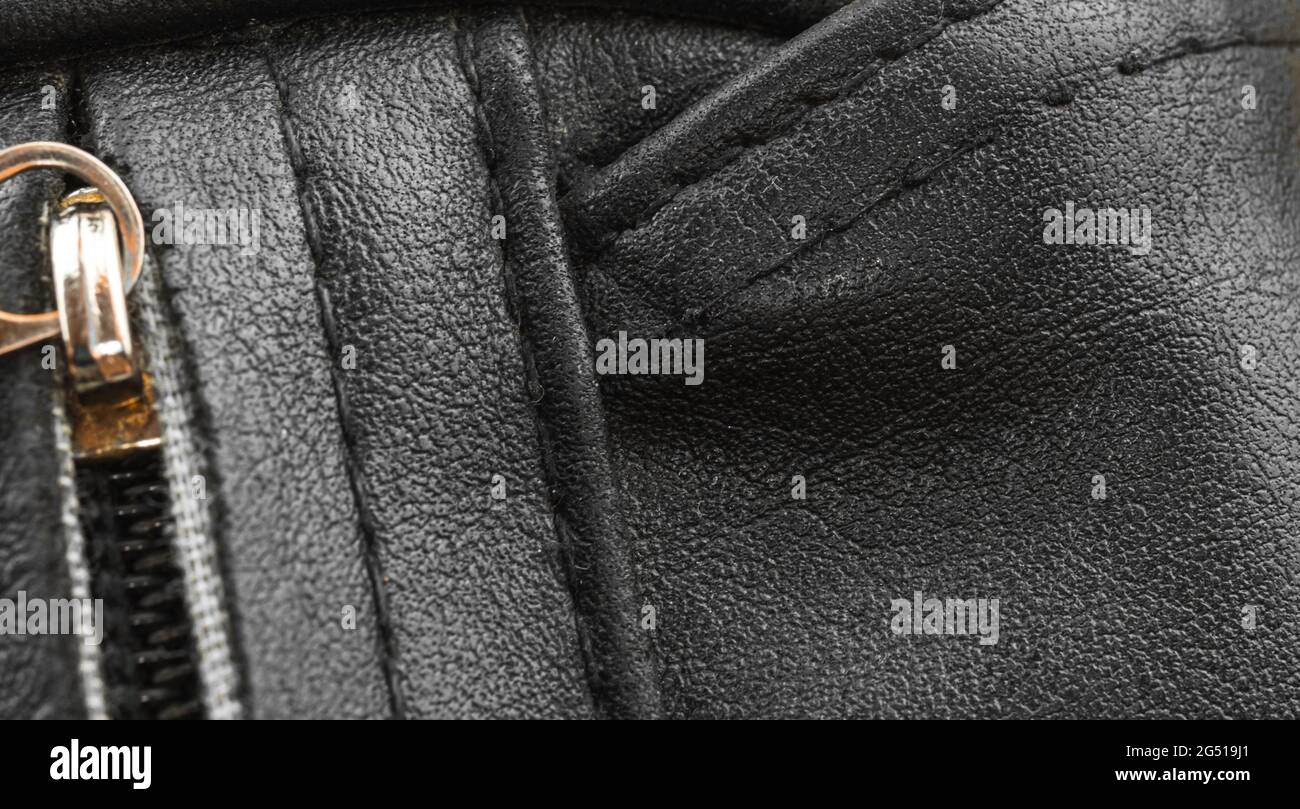 Black leather bag closeup with texture detailed surface, the seams ...
