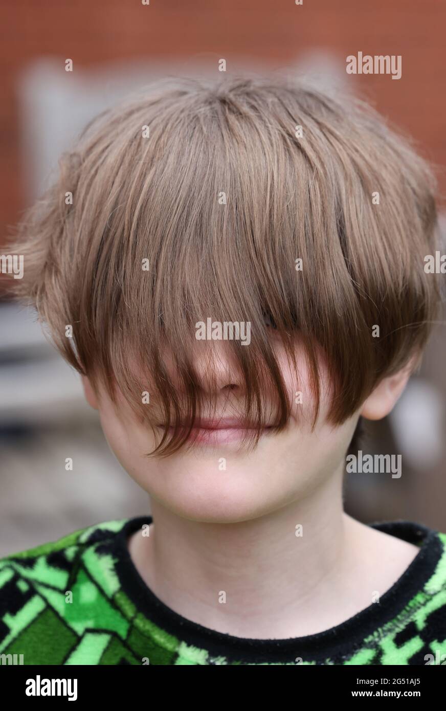 Boy displaying his lockdown hair Stock Photo