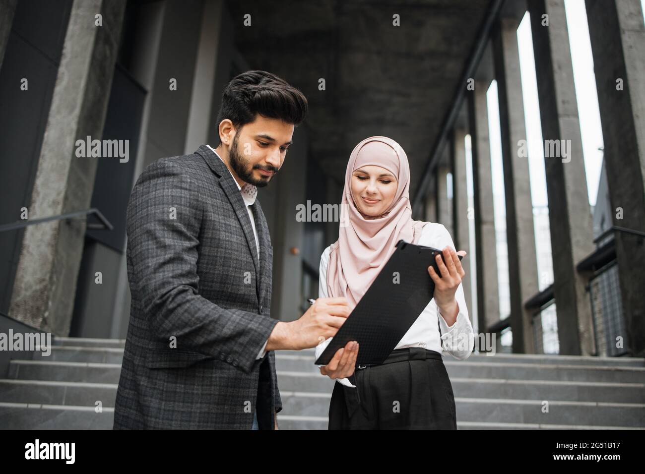 Attractive woman in hijab holding 