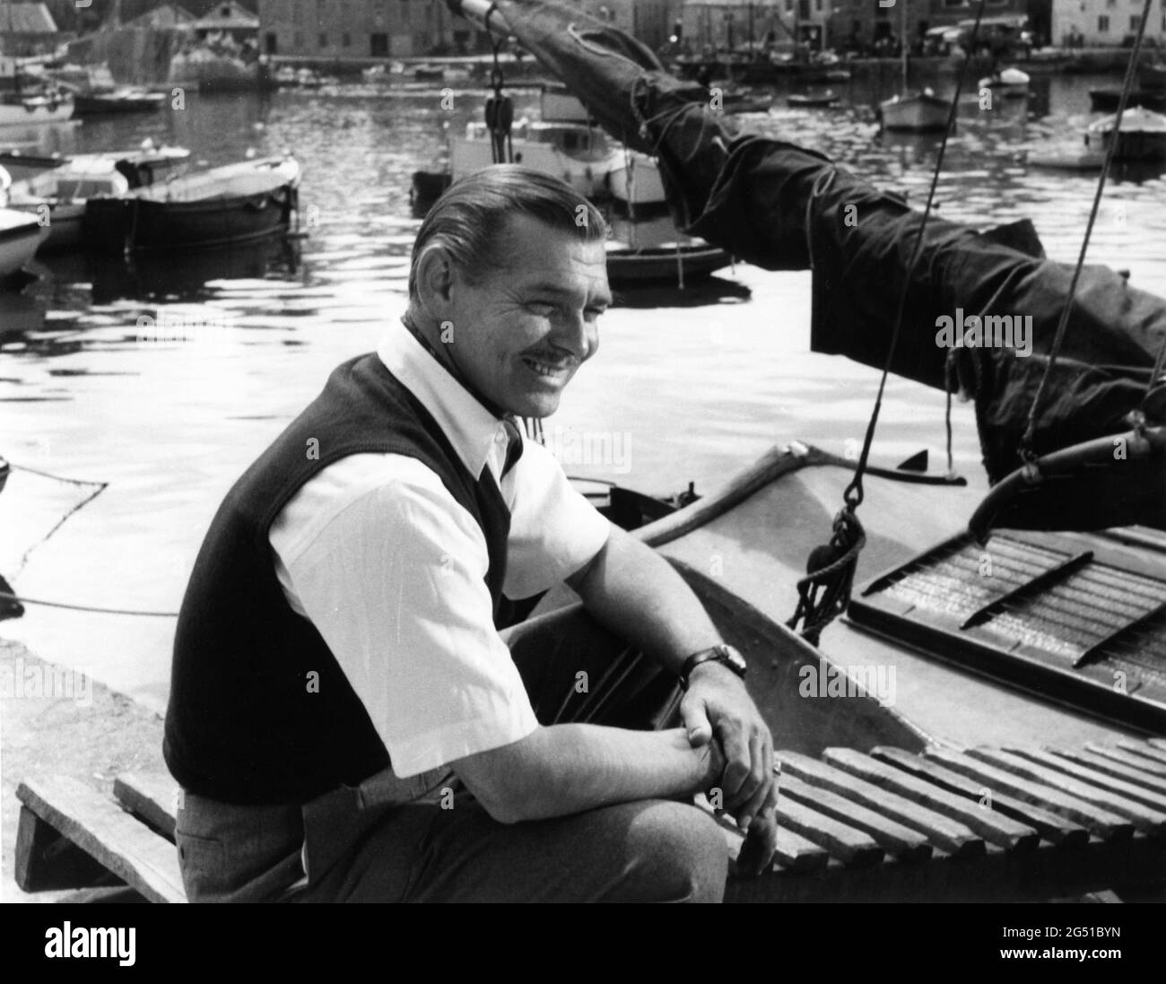 CLARK GABLE on set location candid portrait during filming in Cornwall England of NEVER LET ME GO 1953 director DELMER DAVES from novel Come The Dawn by Paul Winterton producer Clarence Brown Metro Goldwyn Mayer Stock Photo