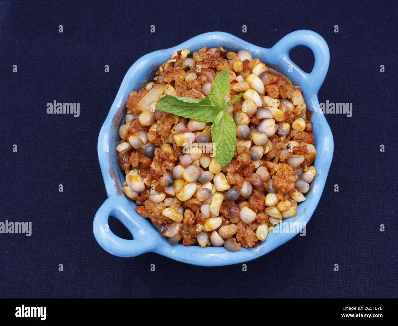 Mexican food as seen from above, corn kernels with chili and longaniza in Mexican casserole. Stock Photo