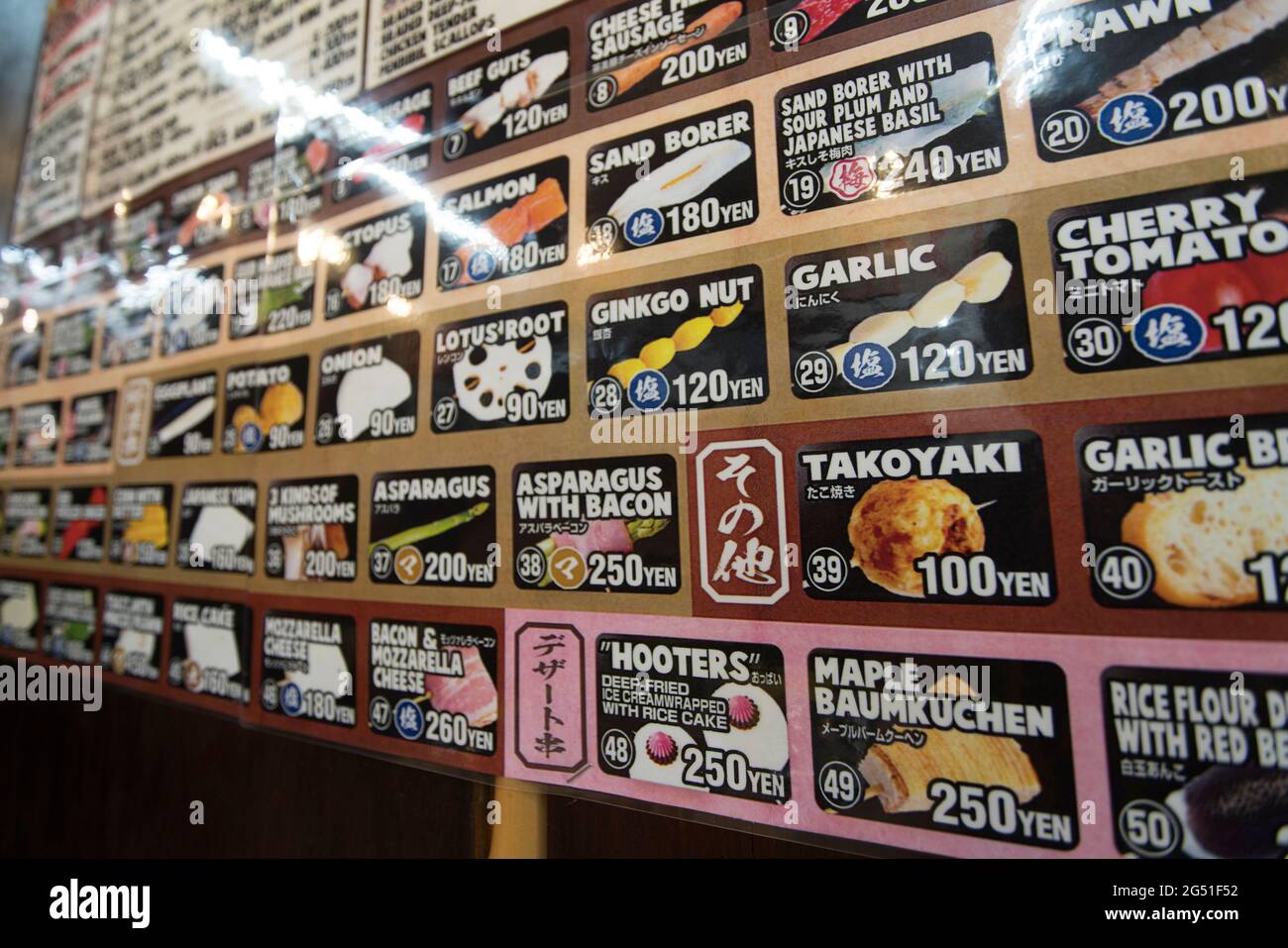 A menu on a wall of a yakitori restaurant in Osaka, Japan Stock Photo