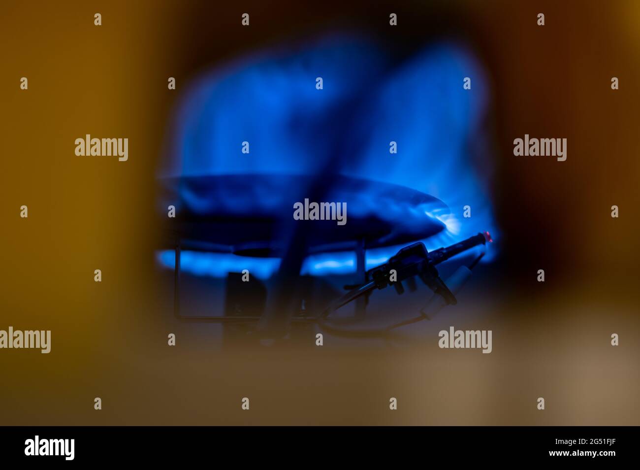 Pilot light auto igniter inside a hot water heater with flames Stock