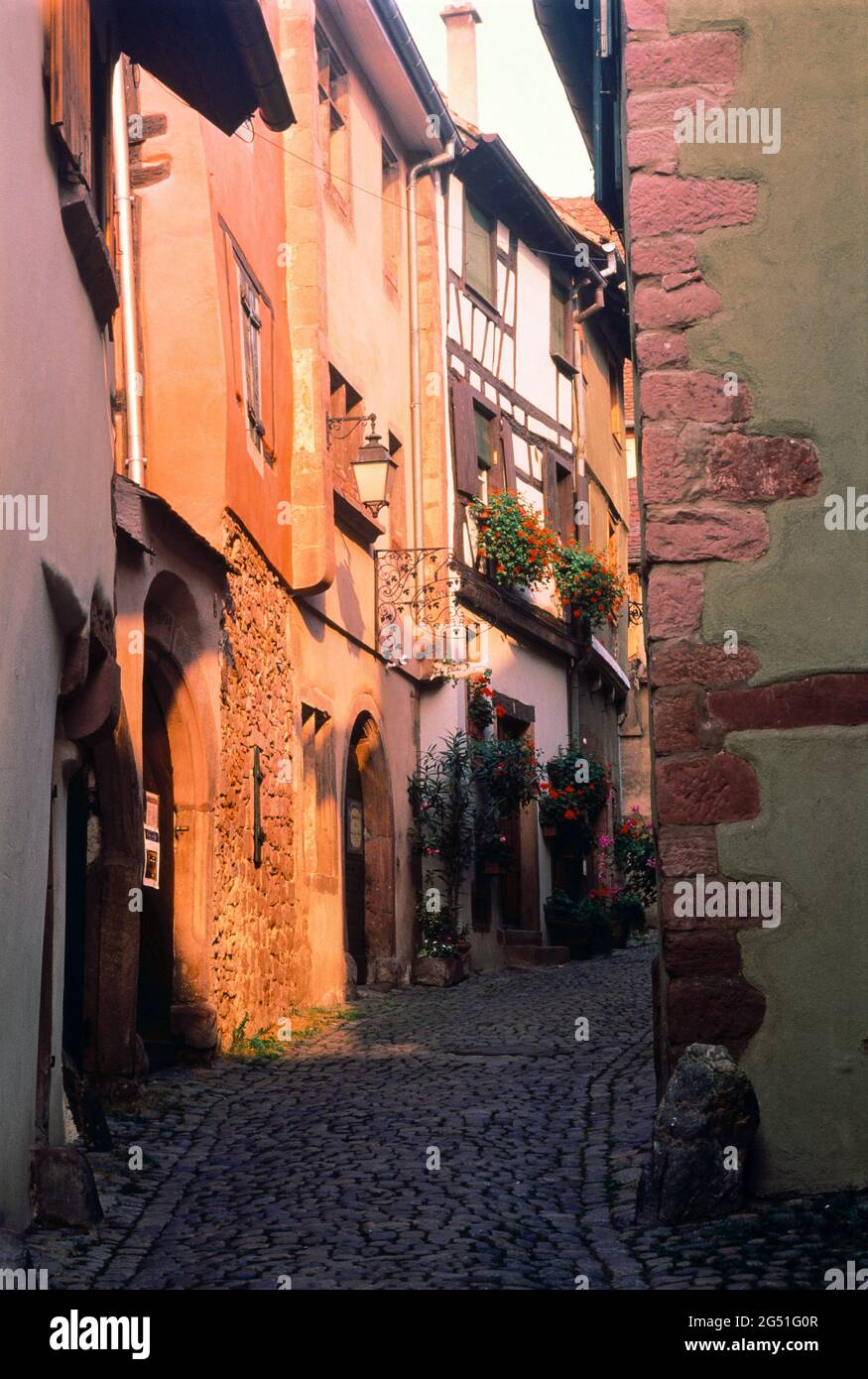 View of street between buildings, Riquewihr, Alsace, France Stock Photo