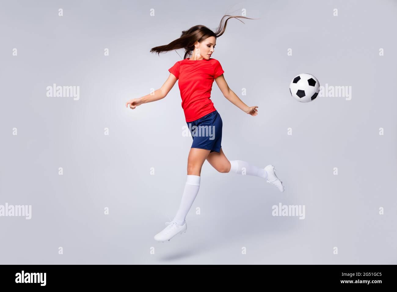 Full length profile photo of lady player soccer team kick ball training