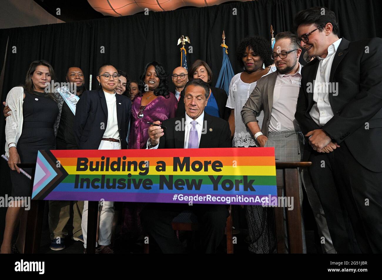 New York, USA. 24th June, 2021. New York Gov. Andrew Cuomo (seated