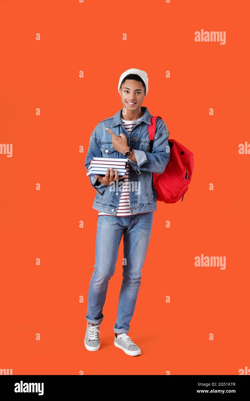 Male African-American student with books on color background Stock ...