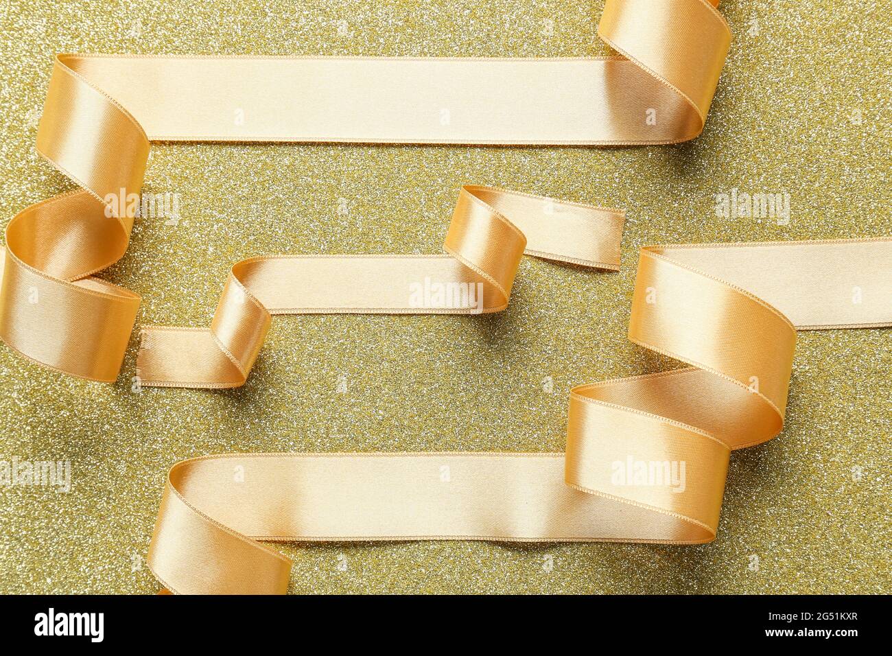 Beautiful golden ribbons on color background Stock Photo - Alamy