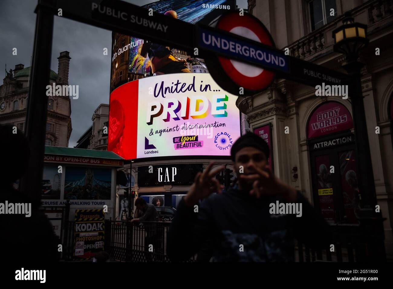 London, United Kingdom, June 24, 2021: People walk by Piccadilly Circus underground station in front of the Pride billboard  as the city celebrates th Stock Photo