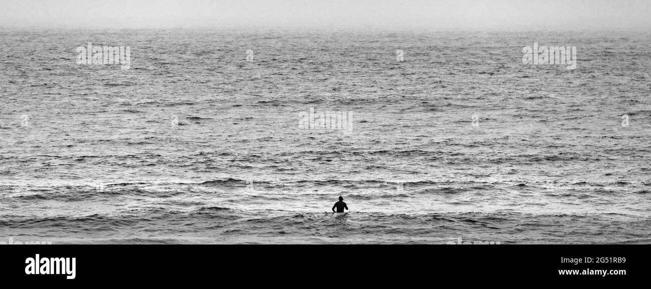 Surfer in Pacific Ocean in black and white, California, USA Stock Photo