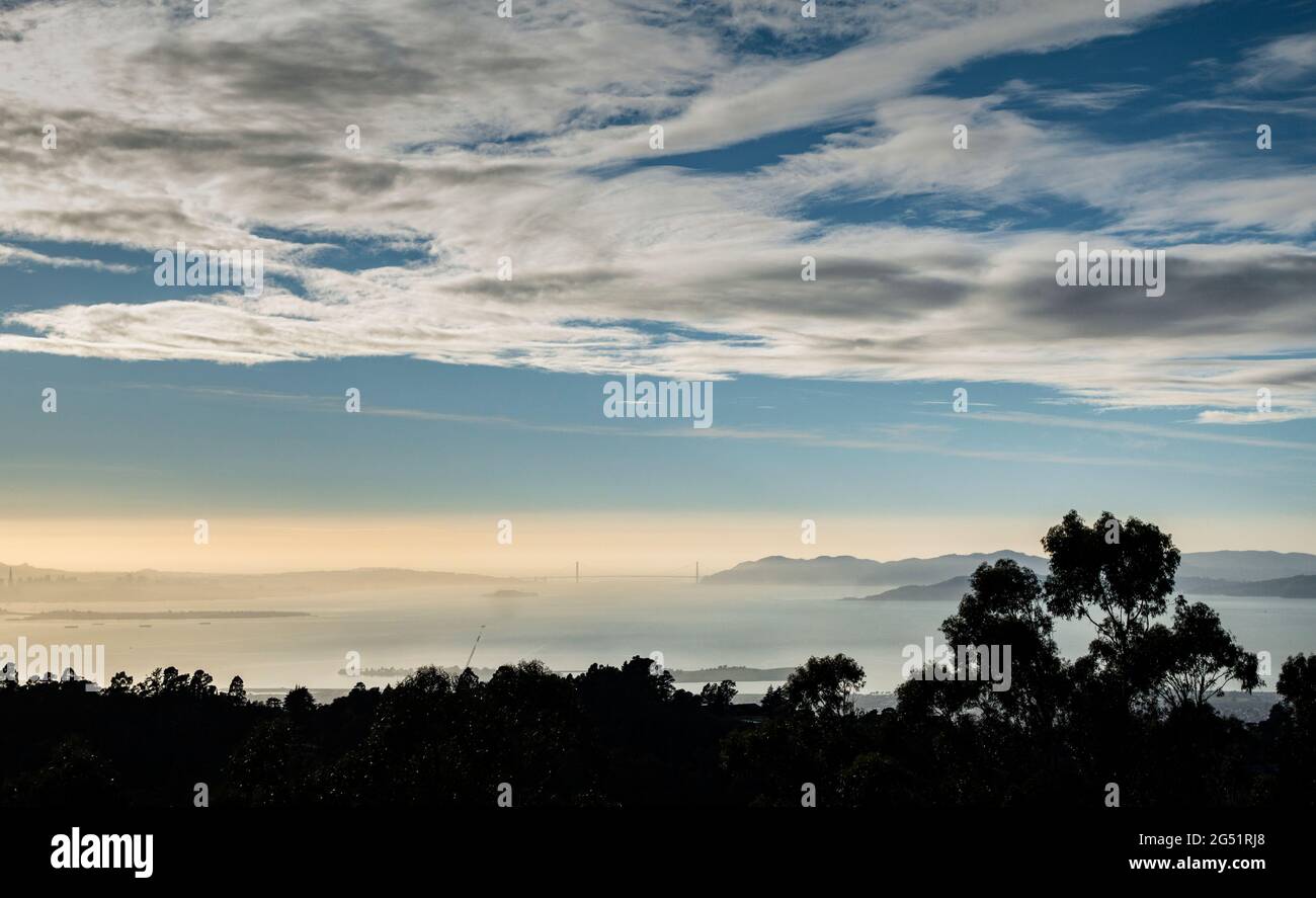 Distant view of Golden Gate Bridge in fog at sunrise, California, USA Stock Photo
