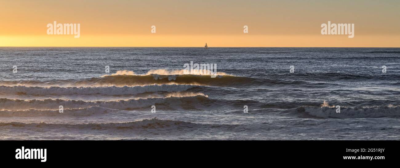 Crashing waves in Pacific Ocean at sunset Stock Photo