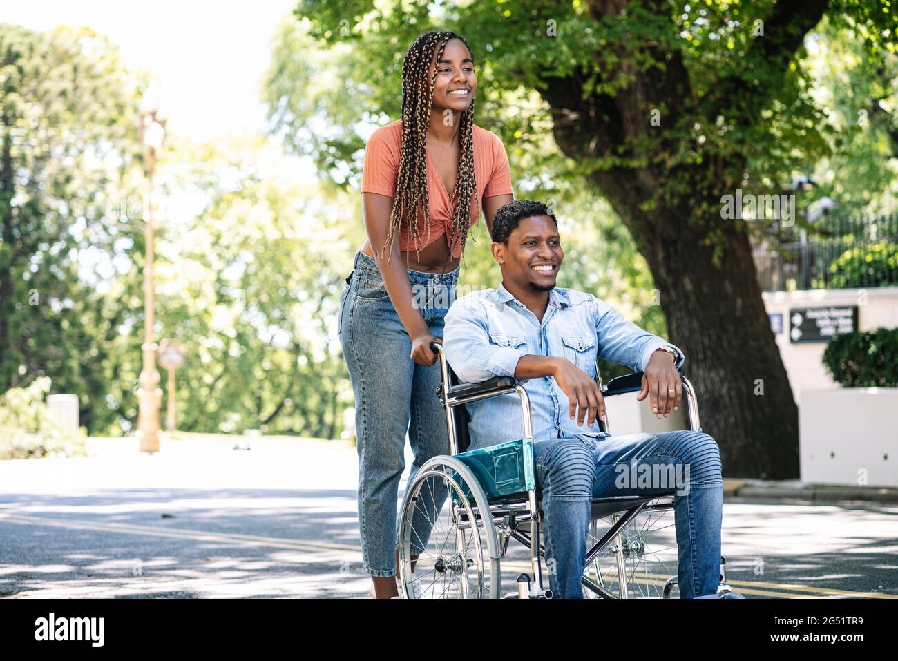 Man in a wheelchair enjoying a walk with his girlfriend Stock Photo - Alamy
